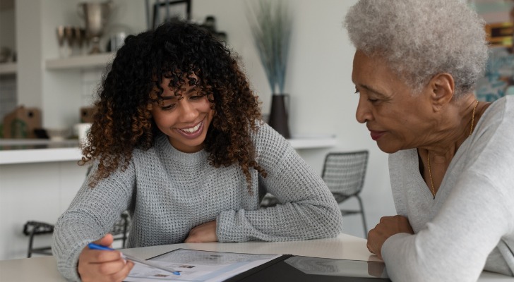 A senior reviewing a tax plan with her granddaughter.