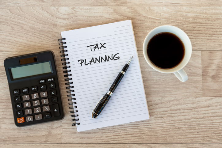 Closeup of a notebook with "tax planning" written in black marker.