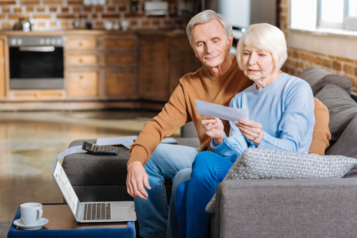 A senior couple reviewing their retirement benefits.