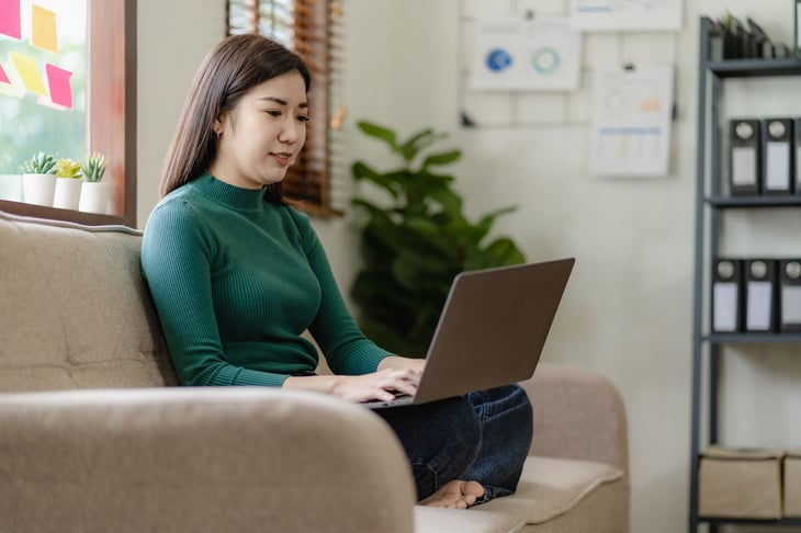Woman using laptop to do AI research