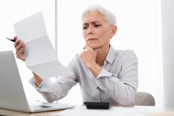 Confused woman working on her taxes